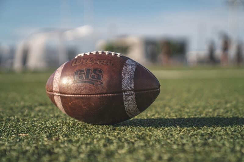 A football on a green field.